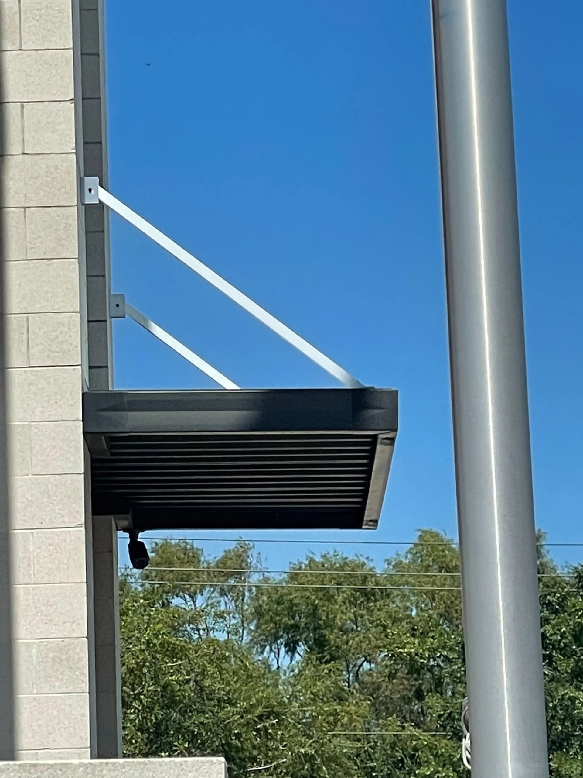 Architectural metal awning on a brick commercial building